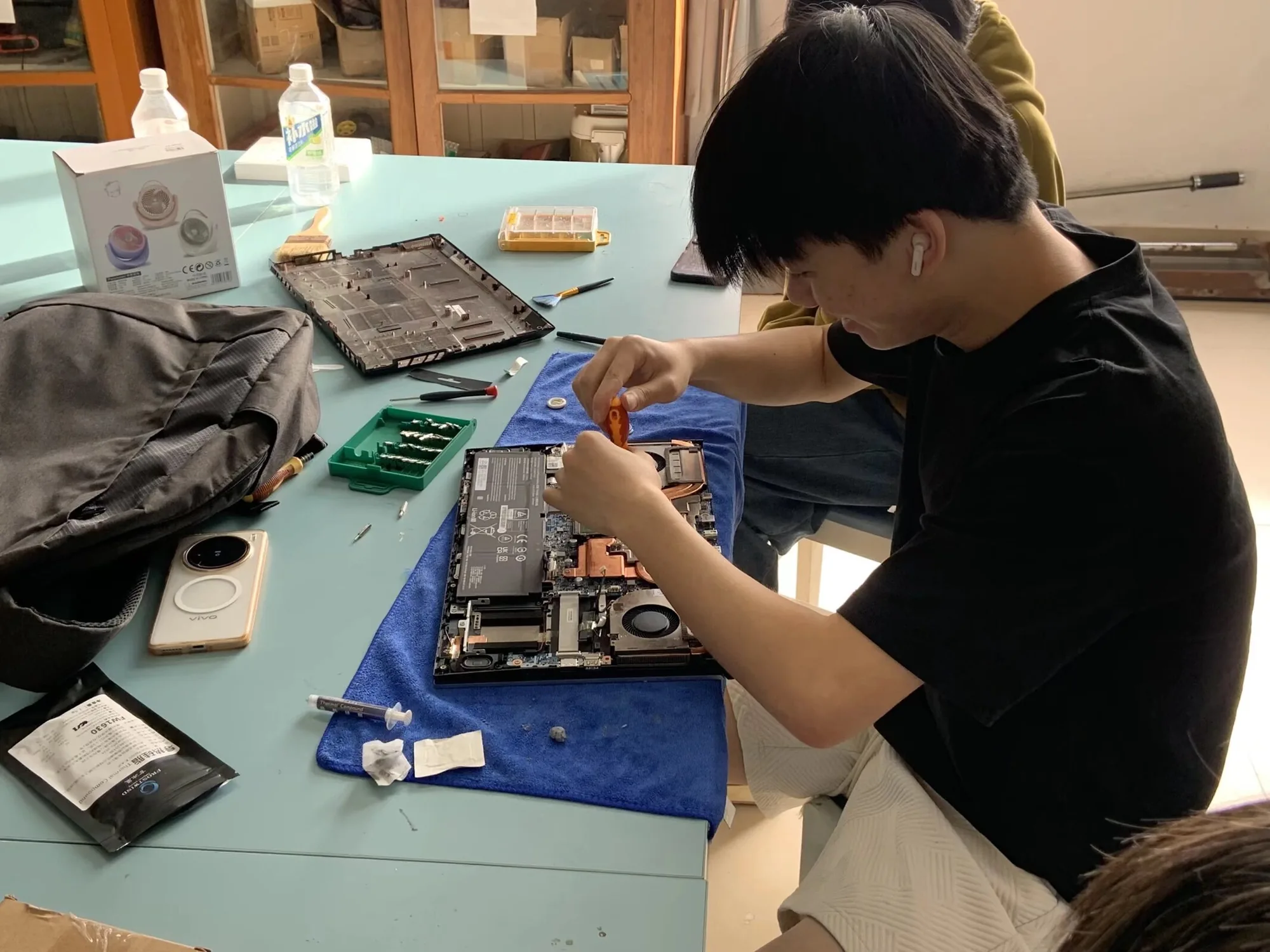 学生在室内工作台前检查电子设备